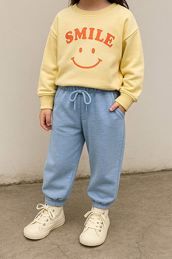 yellow sweatshirt, smiley face, graphic print, blue joggers, drawstring waist, white sneakers, casual outfit, children's clothing, clothing customization