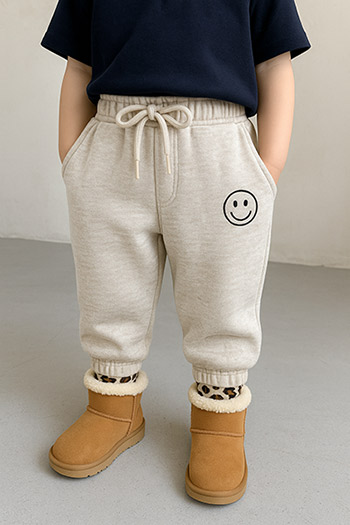 children's joggers, drawstring waist, smiley face patch, leopard print socks, tan boots, casual style, comfortable wear, clothing customization