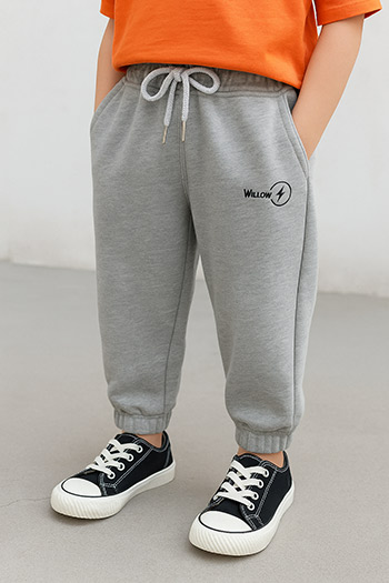 grey sweatpants, drawstring waist, elastic cuffs, graphic print, orange t-shirt, black and white sneakers, casual outfit, children's clothing, clothing customization